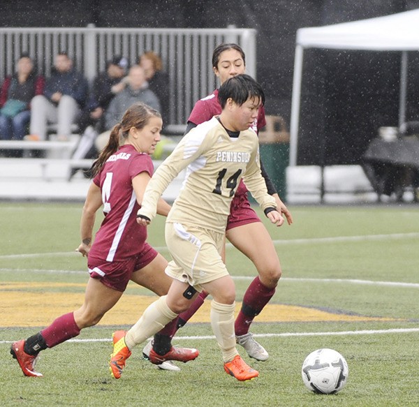 Peninsula's Myu Ban brings the ball upfield in the Pirates' overtime win against North Idaho College on Nov. 7.