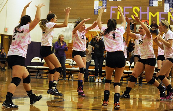 SHS volleyball players celebrate a point as they take on Kingston on Oct. 13. Sequim knocked off the Bucs in the consolation final at the West Central District tournament last week
