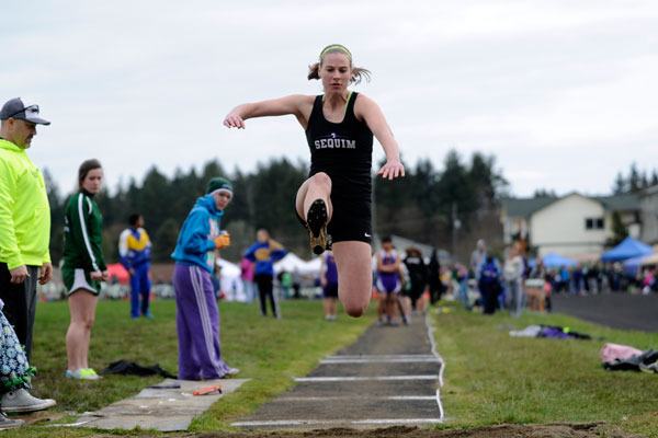 Sequim’s Heidi Vereide launches herself into the pit in the long jump at the Port Angeles Invitational on Saturday. Vereide finished with a 14-foot
