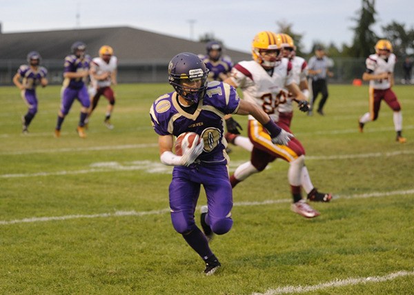 Sequim receiver Ian Dennis races downfield after making a catch.