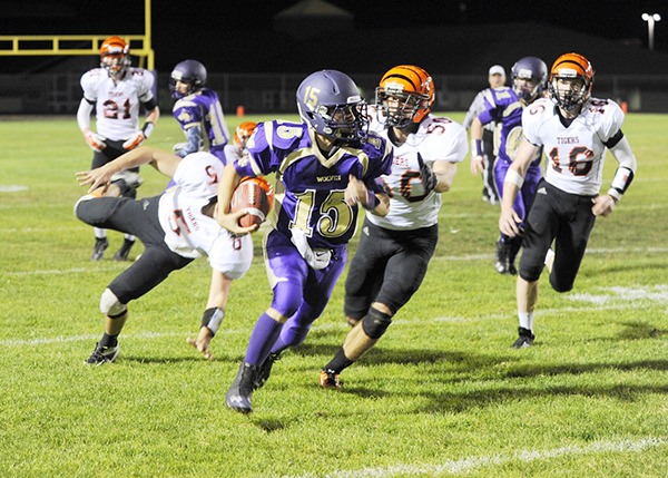 Sequim quarterback Miguel Moroles surges to a first down run against the Centralia Tigers on Oct. 3. The Wolves came close in overtime but lost 34-28.