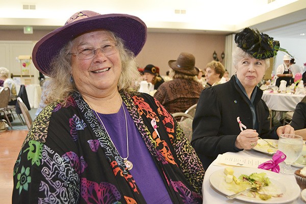 Breast cancer survivor Laurey Hansen-Carl shares a laugh at the Mad Hatter’s Tea Party in 2013 where she shared her journey of healing. Her sister-in-law Deb Keeting-Hansen