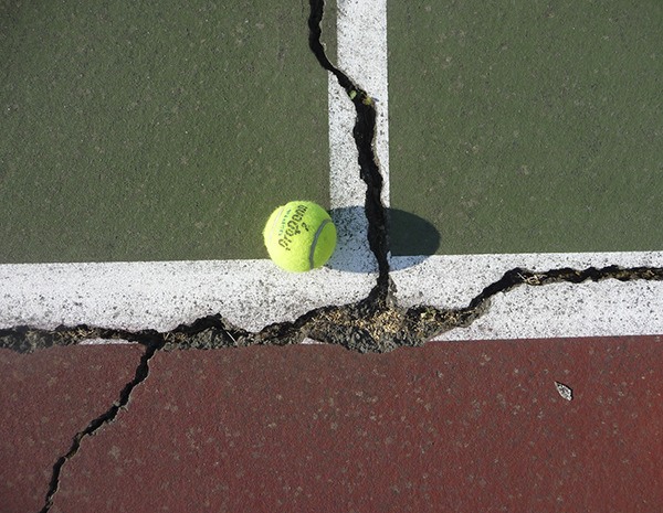 Cracks show at the Sequim High School's recently closed tennis courts.