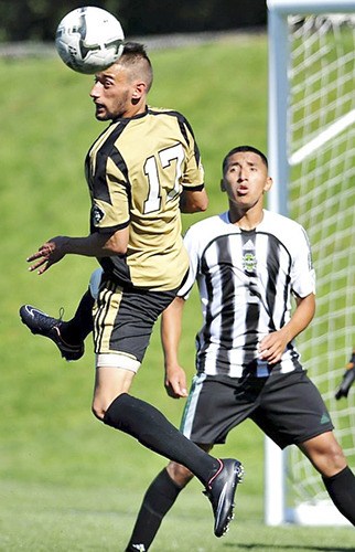 Peninsula's Christopher Galea heads the ball to a teammate as Chemeketa's Jose Reyes looks on.
