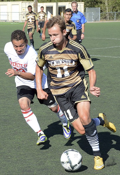 Peninsula College's Sam McEntire dribbles past Everett's Jeyson Ruggerio in a 4-0 PC victory last week.