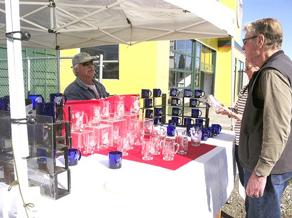 Sequim Farmers Market newcomer Garry Flynn works in both honey and glass.