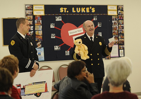 Fire District 3 Chief Steve Vogel and District 3 Capt. Bryan Swanberg accept a check for $22