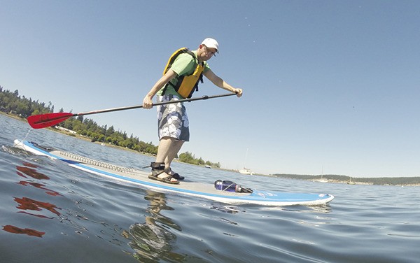 Sequim Gazette editor Michael Dashiell tries his hand at stand up paddling.