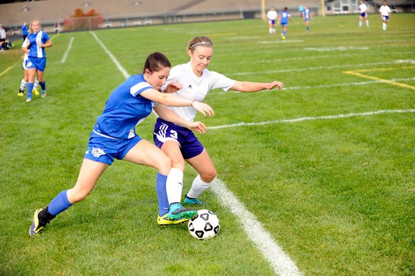 Sequim’s Gretchen Happe fights for the ball against North Mason’s Cheyenne Filer as she goes for a goal on Oct. 17.