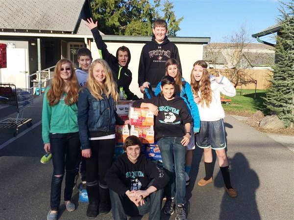 Sequim Middle School students deliver food donations collected during their annual food drive to the Sequim Food Bank. At the end of their annual food drive