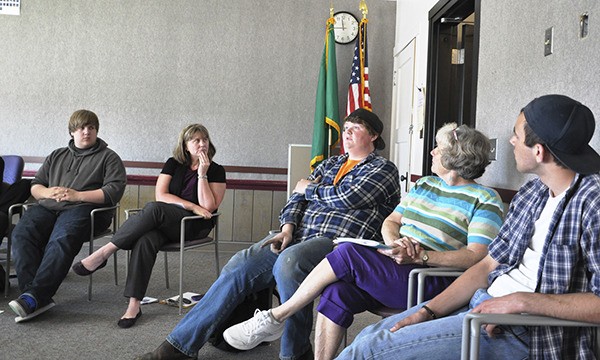 Sequim High School student Josh Henderson (center) talks at a May 20 session of Student Voice. Listening
