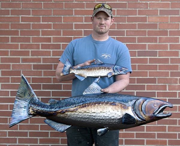 Sequim student-artist Mike Tade displays a recent creation highlighting Pacific Northwest wildlife.