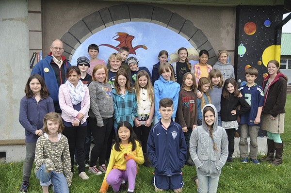 Teachers Tom Harris and Sarah Goff join students in grades 3-7 outside Five Acre School