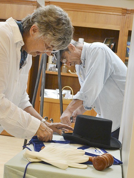 Beverly and John Majors work on the centennial exhibit for the Sequim Masonic Lodge No. 213 inside the Sequim Museum & Arts Center. It debuts Friday