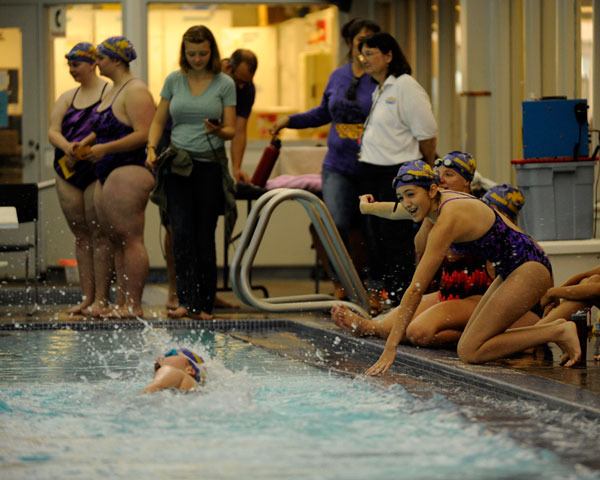 Angela Carrillo-Burge and Annie Armstrong cheer on Madeline Patterson in the 100 freestyle on Sept. 10 in the Lady Wolves' opening swim meet of the year at SARC.
