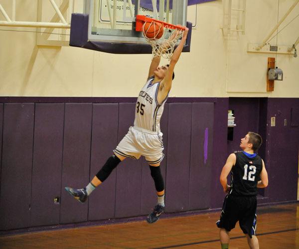 Sequim High senior Alex Barry throws down a dunk as Sequim knocks off North Kitsap on Feb. 3. Barry was selected an honorable mention on The Associated Press All State Basketball team.