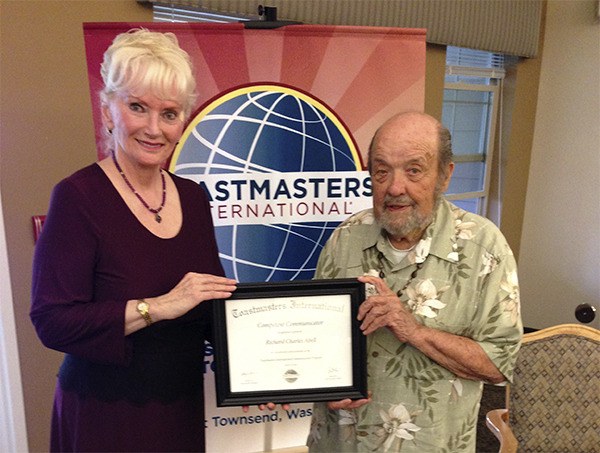 Richard Abell of the PT Smooth Talkers Toastmaster Club is awarded his Competent Communications Certificate by president Victoria Kelley.
