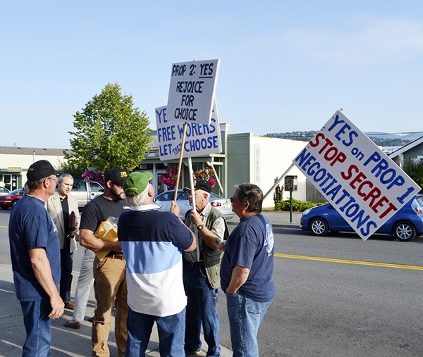Opponents and proponents of Propositions 1 and 2 rally in front of the Sequim Transit Center on Aug. 25 for and against initiatives that could open union collective bargaining labor negotiations to the public and could prohibit mandatory union entry for employment and prohibit work stoppages in Sequim.