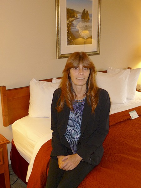 Quality Inn & Suites general manager Nancy Merrigan poses in one of 60 rooms to be decorated this winter.