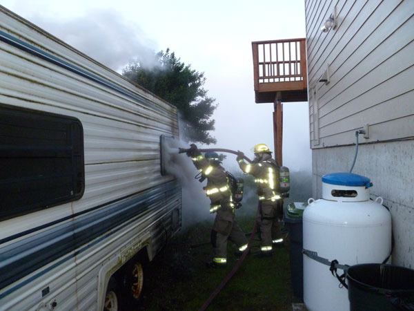 Fire crews extinguish an RV fire on May 21 on Three Crabs Road.