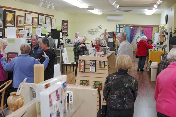 Art enthusiasts fill Colors of Sequim during the First Friday Art Walk on April 3. The art store is currently for sale after operating for more than two years on Washington Street.