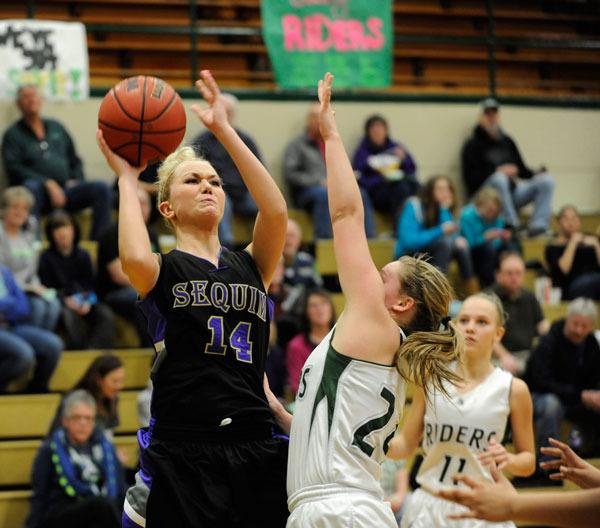 Caitlin Stofferahn goes up for a jump shot over Hayley Baxley in a 38-27 loss to the Port Angeles Roughriders.