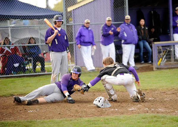 Sequim catcher Ian Dennis takes a throw to tag out Nash Gowin at the plate in the fourth inning of an Olympic League matchup on April 23. North Kitsap topped Sequim 10-4.
