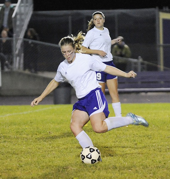 Sequim's Mattie Clark rears back to pass and teammate Erin Vig looks on as the Wolves battle Port Angeles on Sept. 24 in Sequim.