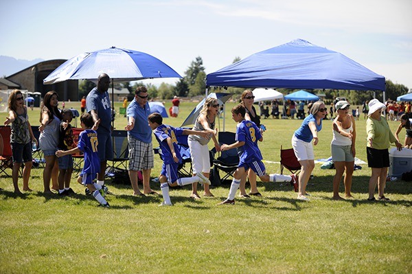 North Kitsap Ballistic fans give their team high-fives after winning their age bracket at the Dungeness Cup in 2012.