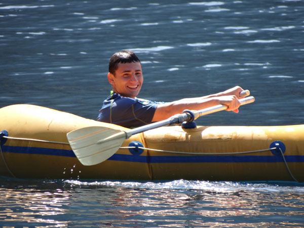 Logan Grajales of Sequim goes for a paddle as fellow campers visit Lake Crescent last week.