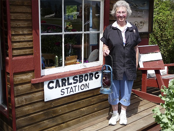 Joyce Horner smiles at the Carlsborg “depot” that her barbershop customers built for her in 2000. She’s moving to California this weekend.