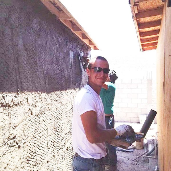 Calvin White works on the house he recently helped to build in Tijuana