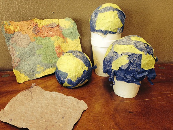 Sequim Boys & Girls Club campers make their own colorful paper by recycling other used papers and shape some of it into their own globes.