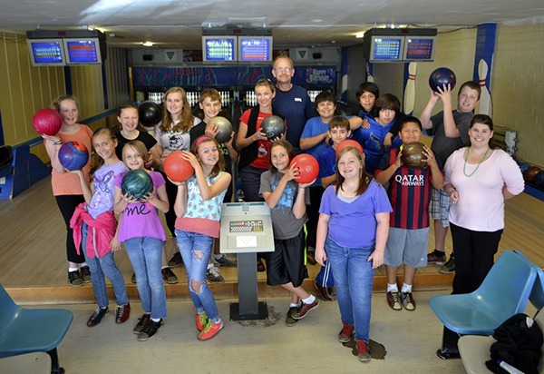 Sixth-graders in Casey Lewis’ classes from Sequim Middle School celebrate the last day of bowling at the Sequim Olympic Lanes by holding a class academic achievement party on June 9. On hand were business managers Mike and Sherrie Elkhart