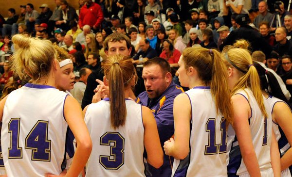 Sequim girls varsity coach Evan Still talks with his players during a crucial moment of a game in 2014. The Sequim School Board accepted his resignation on April 6.