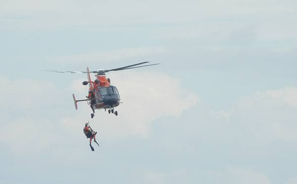 A U.S. Coast Guard rescue swimmer retrieves a kayaker from Dungeness Bay on Aug. 8. It’s the second kayak-related emergency in Dungeness Bay within the past four months.