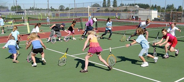 Participants at the Boys & Girls Clubs of the Olympic Peninsula’s 2013 summer tennis camp get busy with a drill.