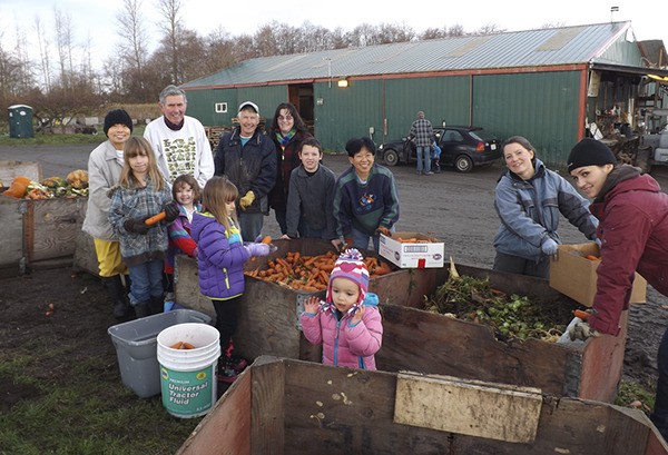 A group of volunteers at Nash’s Organic Produce glean produce mid-December to donate to local organizations. In the back row are Suki Chan