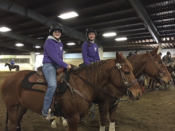 Sequim Equestrian Team members Sydney Balkan (with her horse Kitty) and Yana Hoesel (with Jag) prepare to compete in the Cattle Sorting division of their first meet of the season