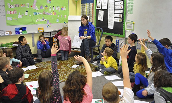 Students of varying grade levels at Helen Haller Elementary School engage in an all-school share session in second-grade teacher Amy Boyer’s classroom during the Cougar Writing Conference last week. Each student had an opportunity to share their writings and offer feedback.