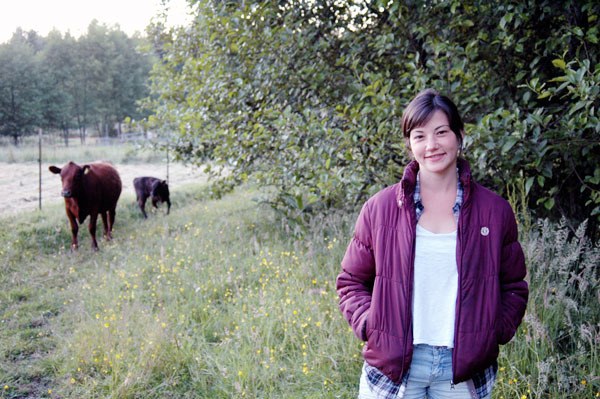 Reporter Alana Linderoth stands near her cows.