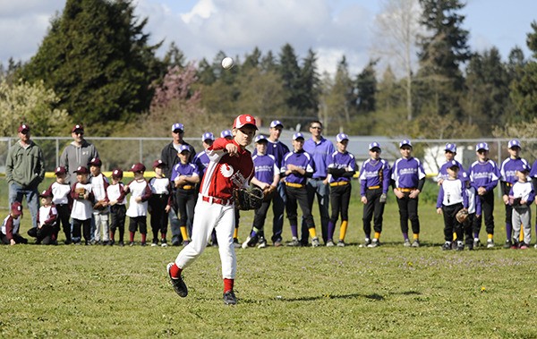 Silas Thomas tosses Sequim Little League's first baseball pitch of the season to Sean Ryan
