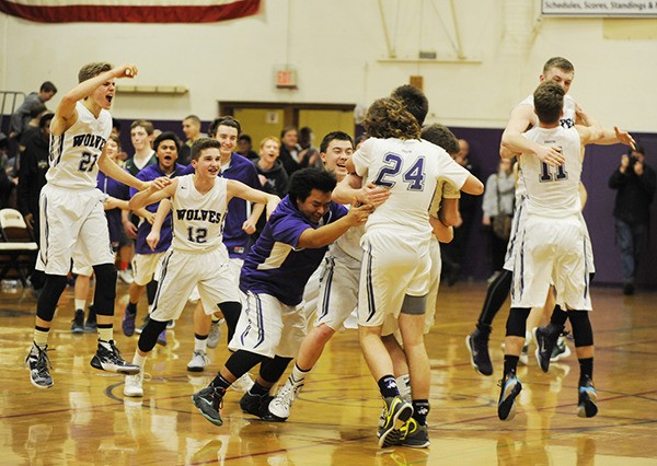 Sequim players celebrate a two-point win against rival Port Angeles on Jan. 29.