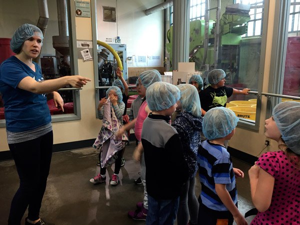 Members of the Boys & Girls Club of the Olympic Peninsula visit the Theo Chocolate Factory recently and learned about the process of sourcing cocoa to roasting.