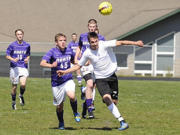 Sequim's Thomas Winfield beats North Kitsap defenders to the ball in the Wolves' 3-1 win on Saturday. Winfield had a goal and an assist.