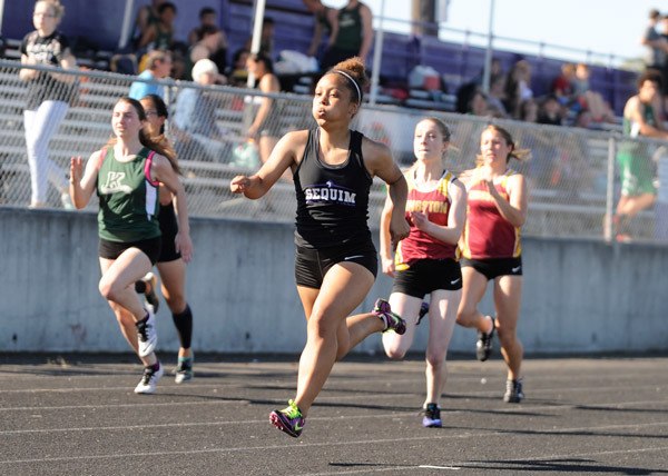 Sequim’s Mercedes Woods rockets down the track for a win in the 100-meter sprint in the Wolves’ home meet against Kingston and Klahowya on April 20. Woods finished in 13.3 seconds