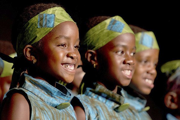 A choir of about 18 Ugandan youths gain the spotlight at an April 15 concert at Eastern Hills Community Church in Carlsborg.