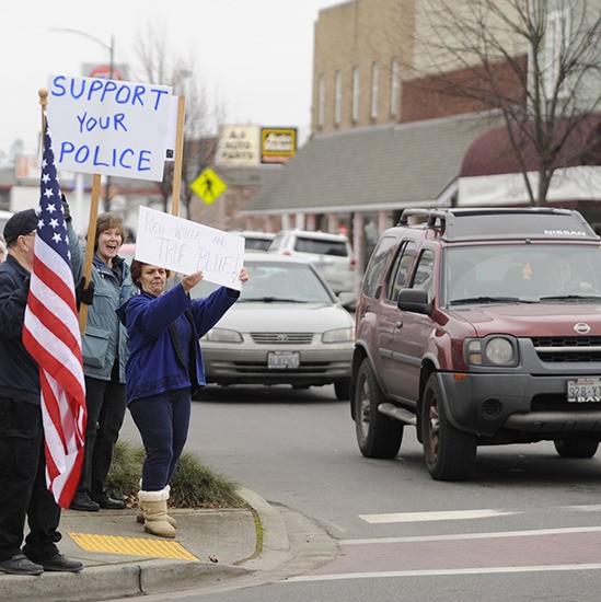 A group of locals organized by the Concerned Citizens of Clallam County rallied on Jan. 9 at the corner of Washington Street and Sequim Avenue waving signs and American flags to show their support for law enforcement. Above