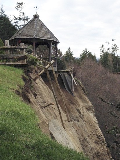 A gazebo teeters on the edge of the eroding bluffs between Sequim and Port Angeles shortly before it fell to the beach far below.
