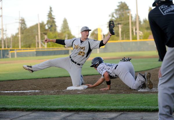 First baseman Dan Harker for the Olympic Crosscutters tags out a base runner from the Lower Columbia Silver during the American Legion AA District 2 Regional Tournament on July 17 in Civic Field.